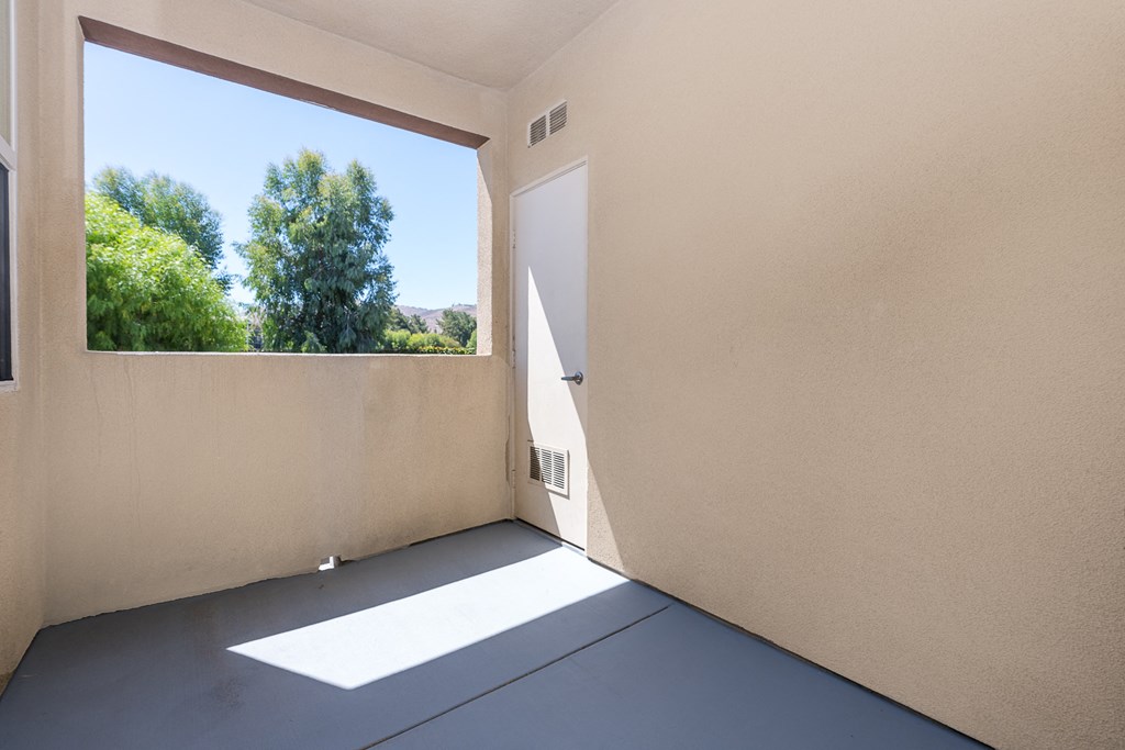 a patio with a large window and a door