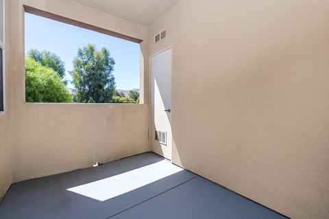 a patio with a large window and a door