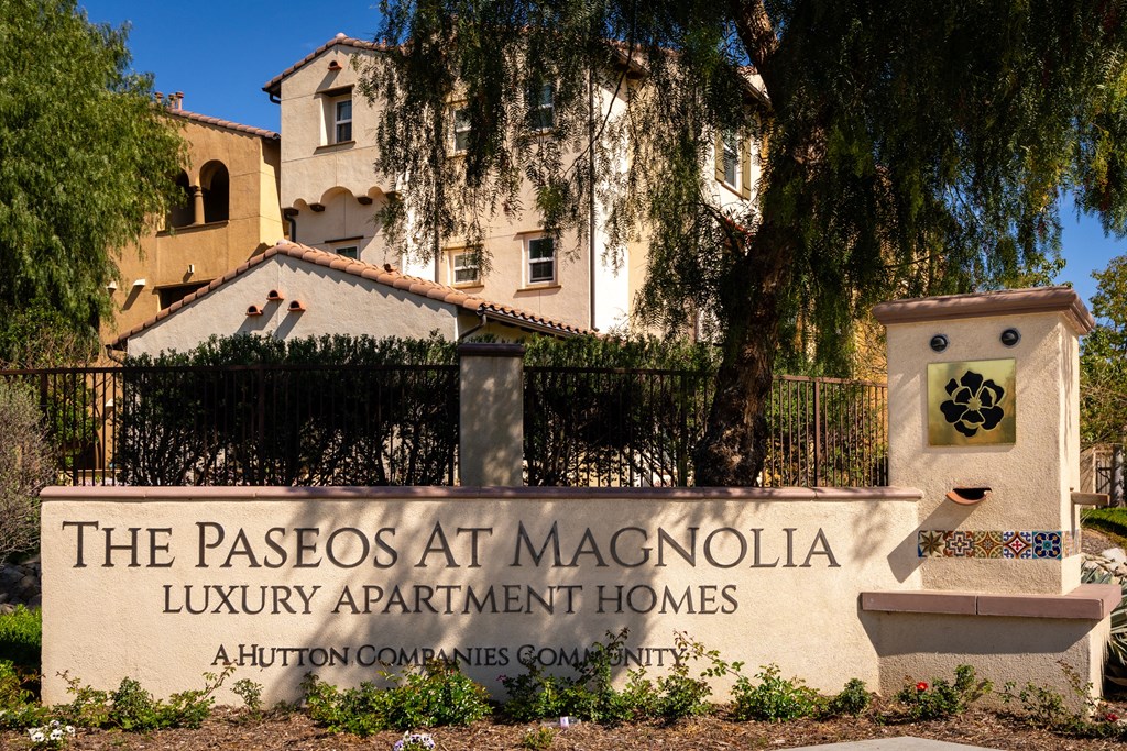 Entrance sign of Paseos at Magnolia Apartment Homes
