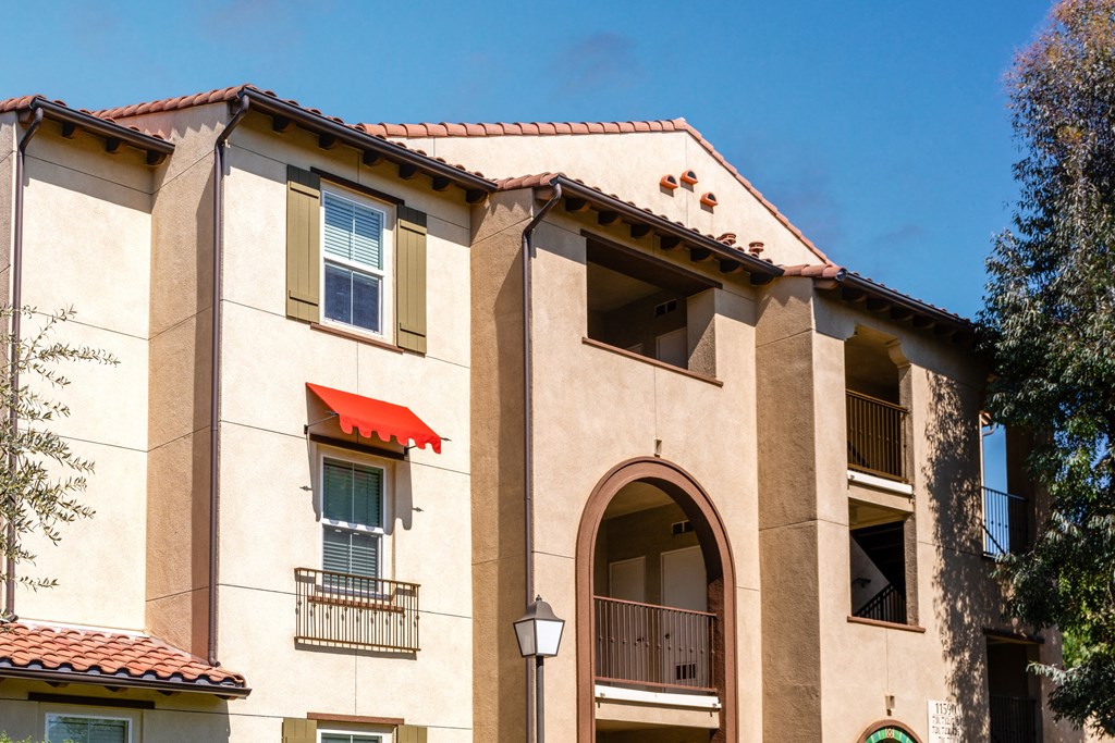 a building with a red roof and a blue sky