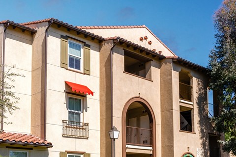 a building with a red roof and a blue sky