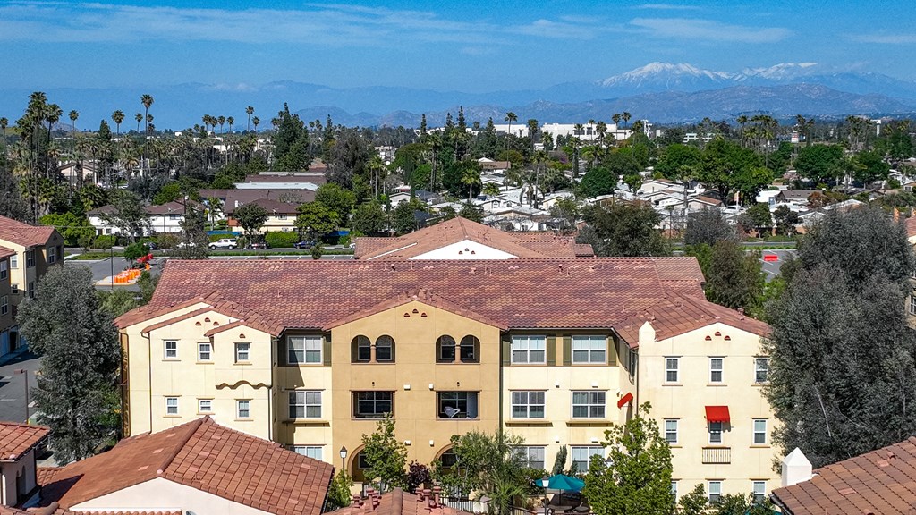 a view of the city and mountains from the top of a building