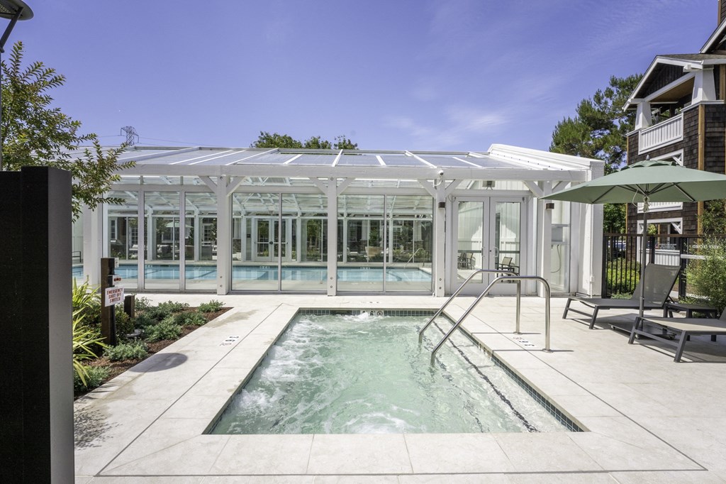 a pool and glass greenhouse in a house