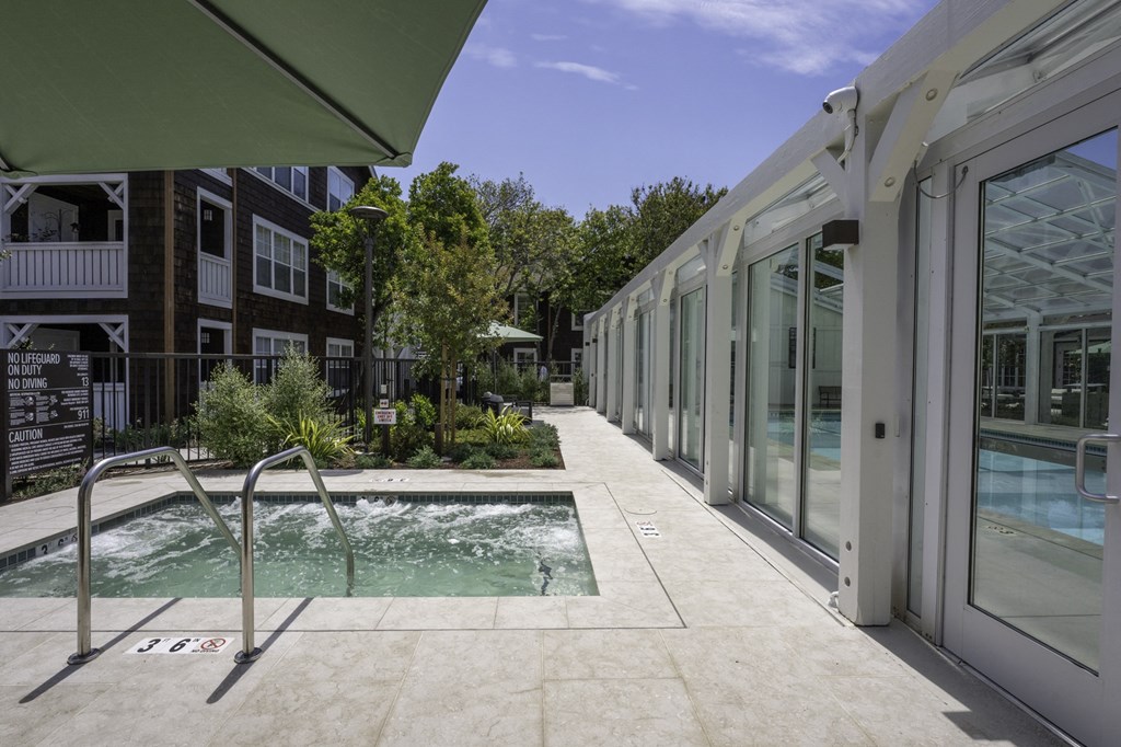 the pool area of a building with a pool and glass doors
