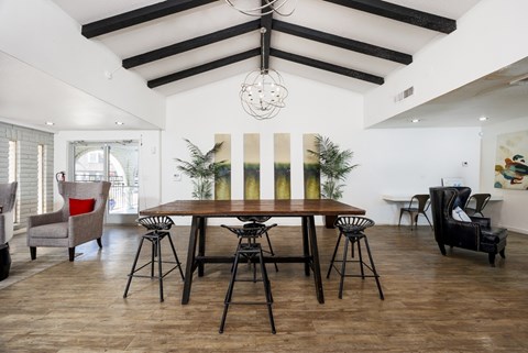 A dining room with a wooden table and chairs.