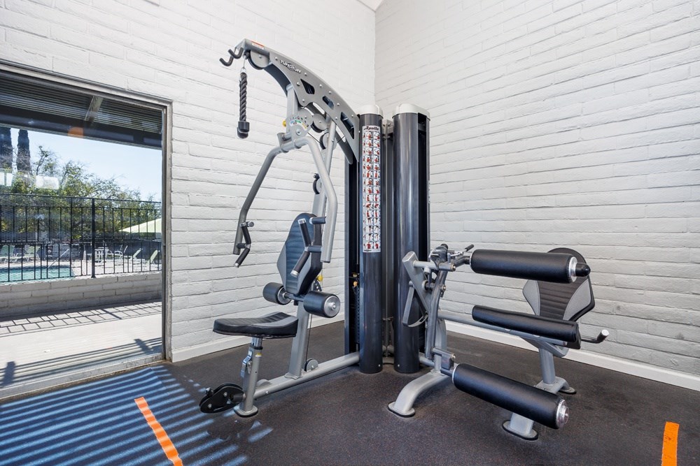 A gym machine is in front of a window.