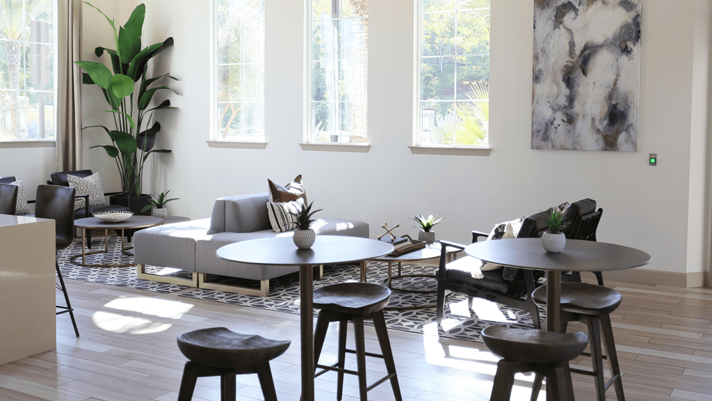 stylish leasing lobby with lounge chairs and high top seating