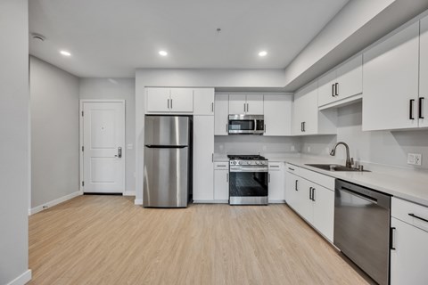 A kitchen with white cabinets and stainless steel appliances.