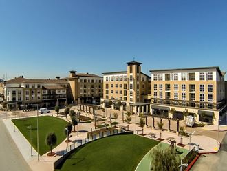 Apartments in Foster City, CA - The Plaza - Exterior Apartment Building with Parking Lot and Trees
