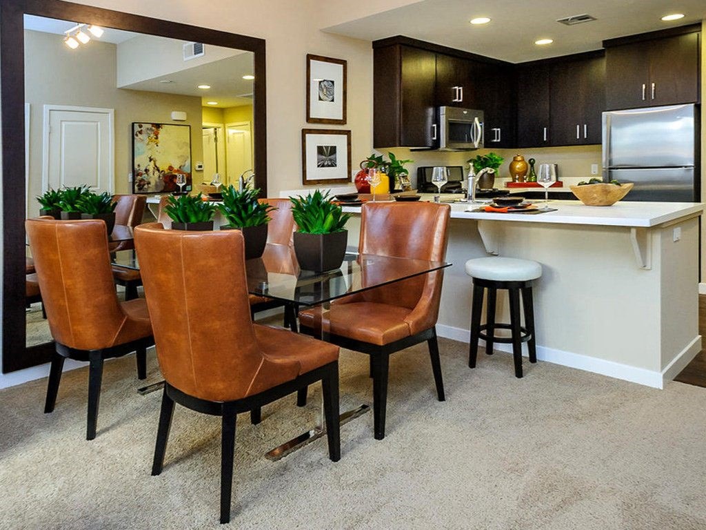 a kitchen and dining room with a table and chairs