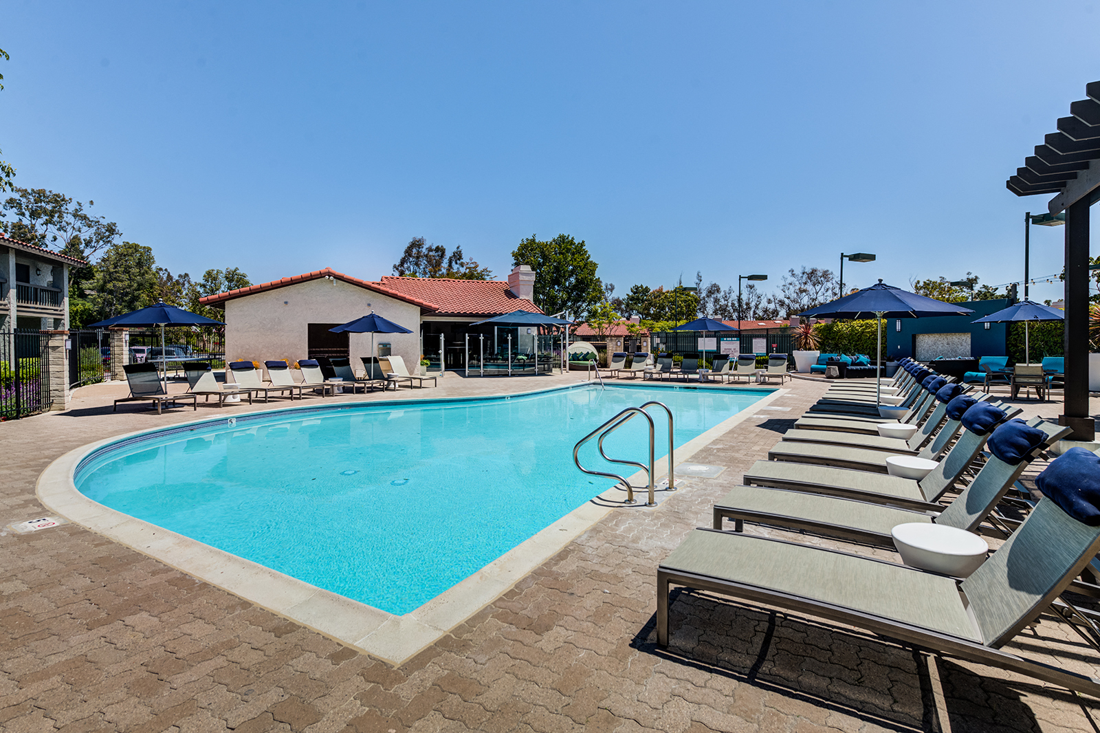 Outdoor pool area with lounge chairs