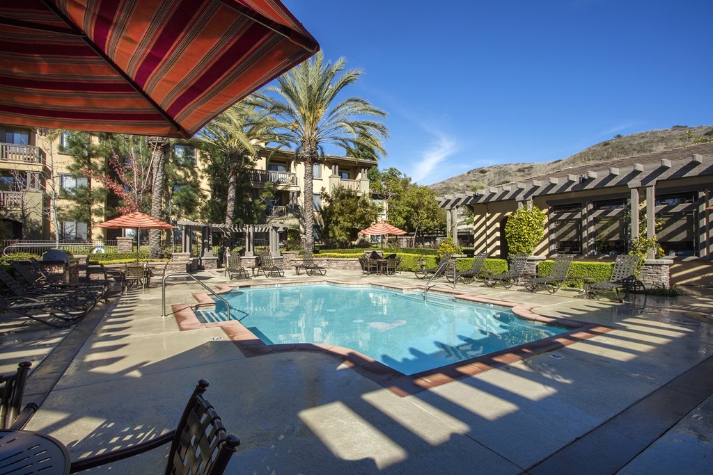 Pool with Lounge Seating, Umbrellas, and Tables at 55+ Remington at Ladera Ranch, California, 92694
