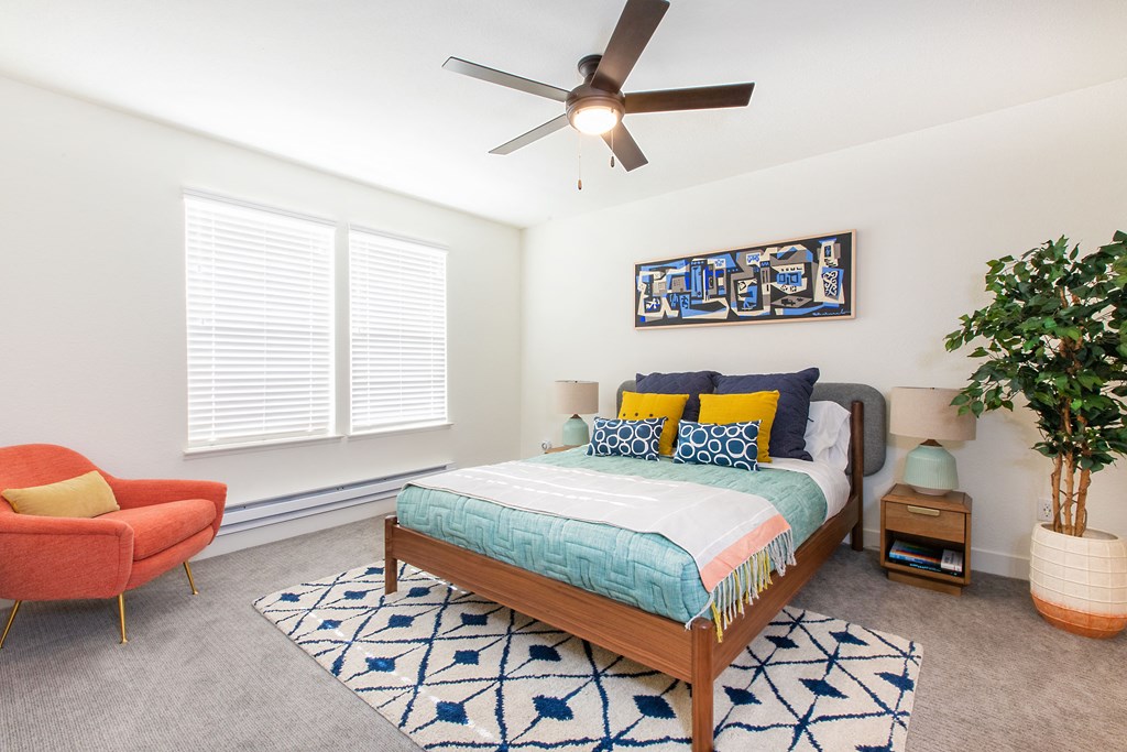 a bedroom with a large bed and a ceiling fan