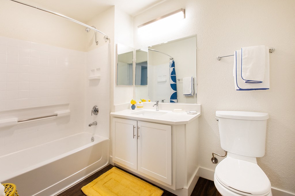 a bathroom with a bathtub sink and toilet