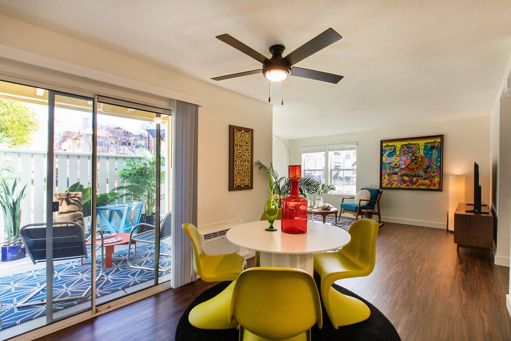 a dining room with a table and chairs and a ceiling fan