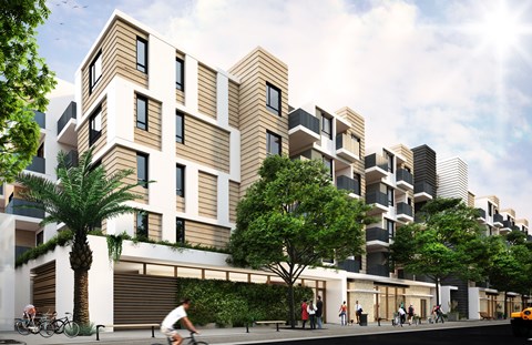 A modern apartment complex with a courtyard and trees.