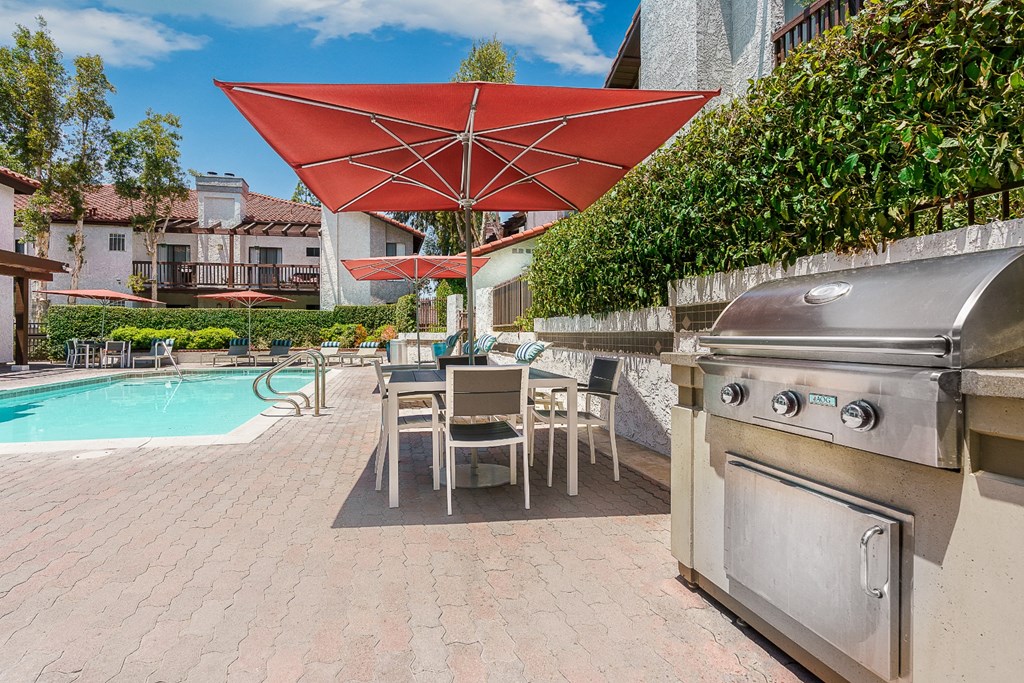 Pool lounge area with BBQ grills at Ridgecrest, Lake Forest