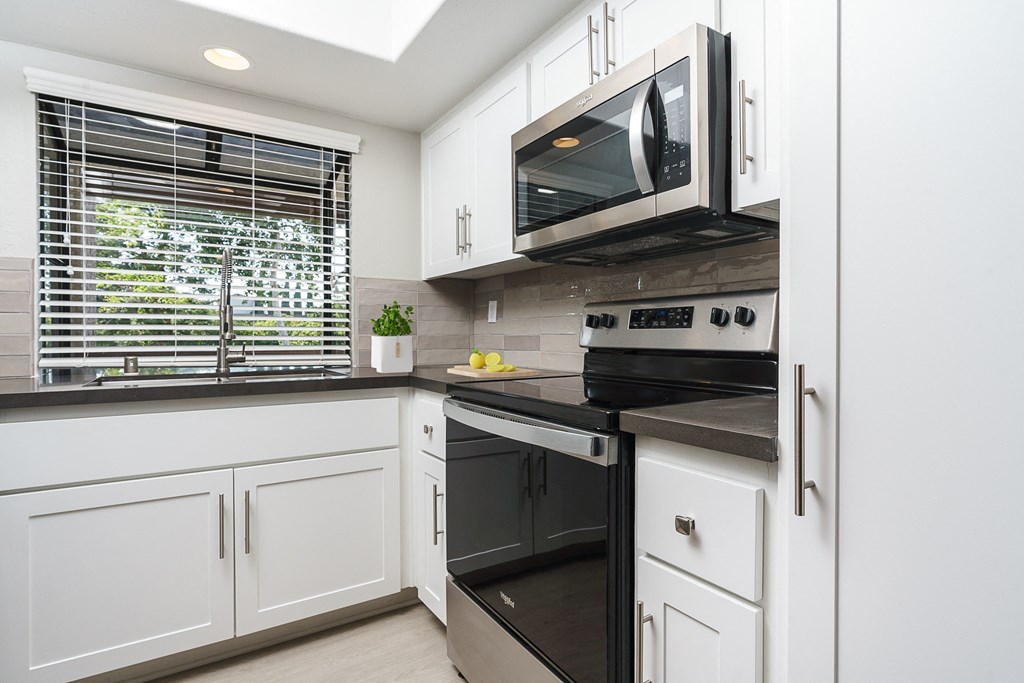 Kitchen with bay window, stove and microwave at Ridgecrest, Lake Forest, CA, 92630