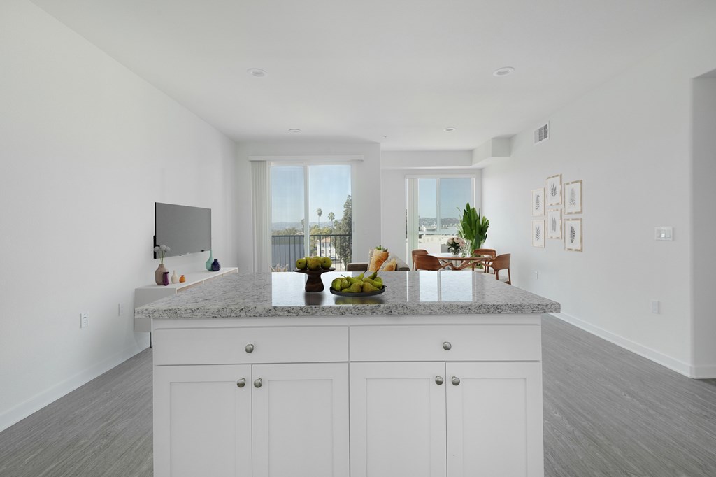 A kitchen with white cabinets and a marble countertop.at 422 South Lake, Los Angeles  