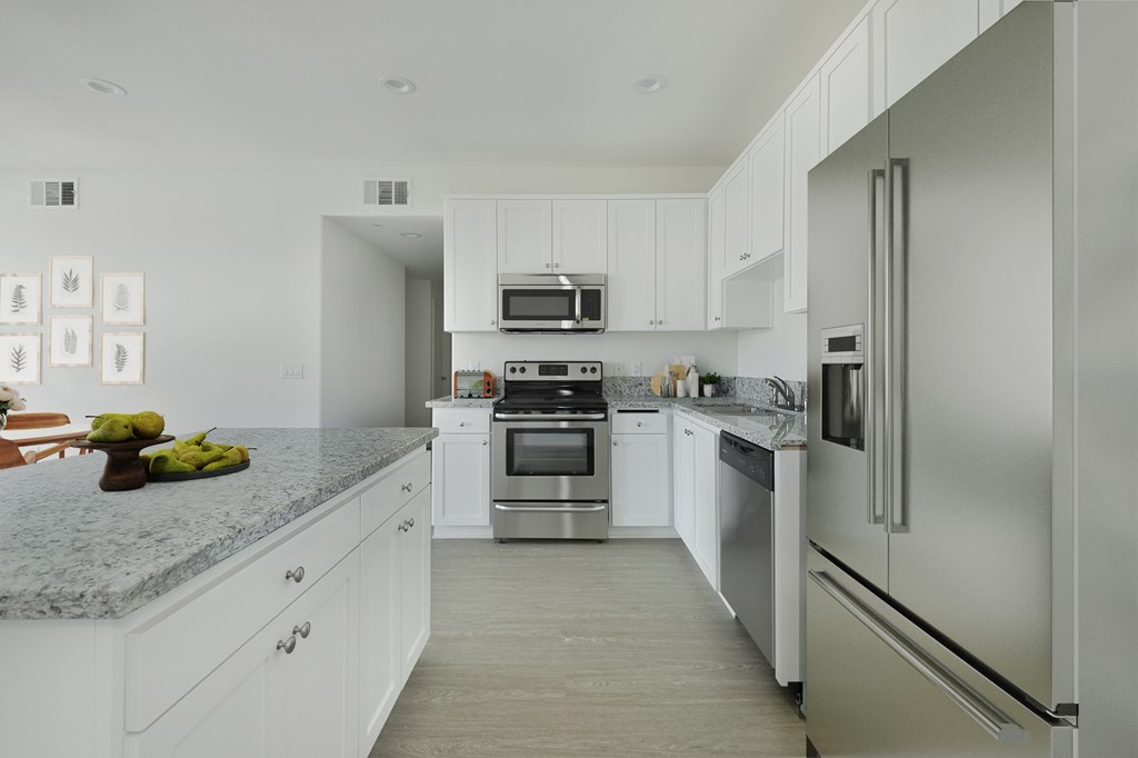 A modern kitchen with stainless steel appliances and white cabinets.at 422 South Lake, Los Angeles, CA  