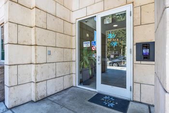 a door to a building with a sign on the side of it