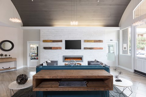 a living room with a blue couch and a fireplace