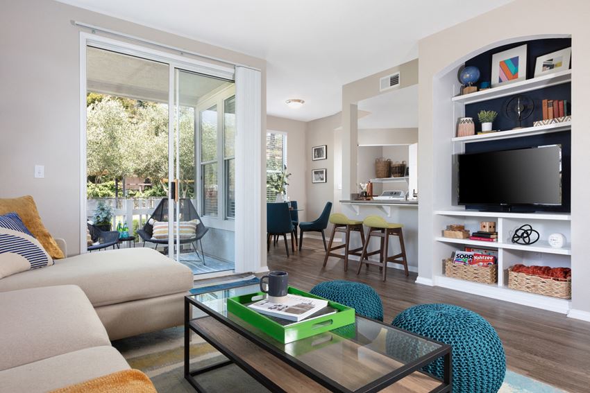 Apartments for Rent in Napa CA - Montrachet - Living Area with Beige Interiors, Wood-Style Flooring, and Sliding Glass Patio Doors - Photo Gallery