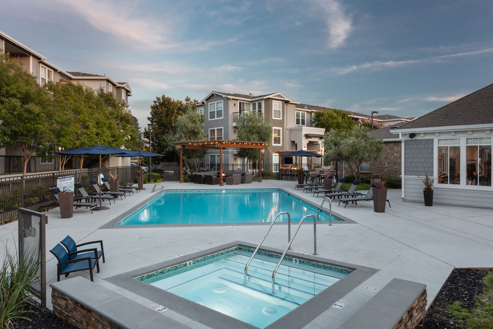 Apartments in Napa for Rent - Montrachet - Resort-Style Pool Area with Jacuzzi, Lounge Chairs, and Umbrellas