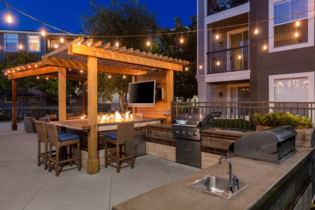 Outdoor grill and seating area with TV