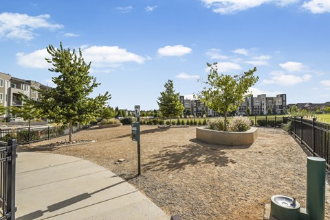 a park with trees and a fence and a city in the background at Parkside at Littleton Village, Colorado, 80122