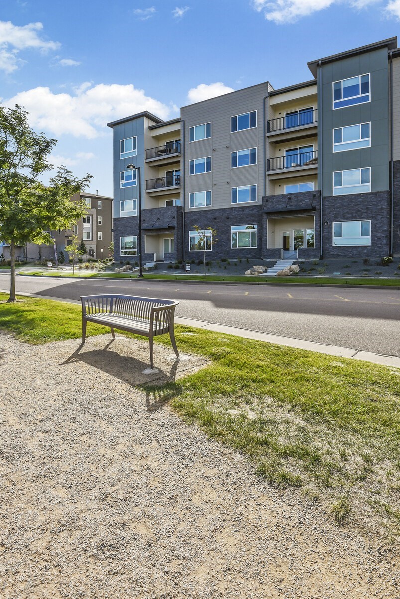 a park bench sitting on the side of a street at Parkside at Littleton Village, Littleton