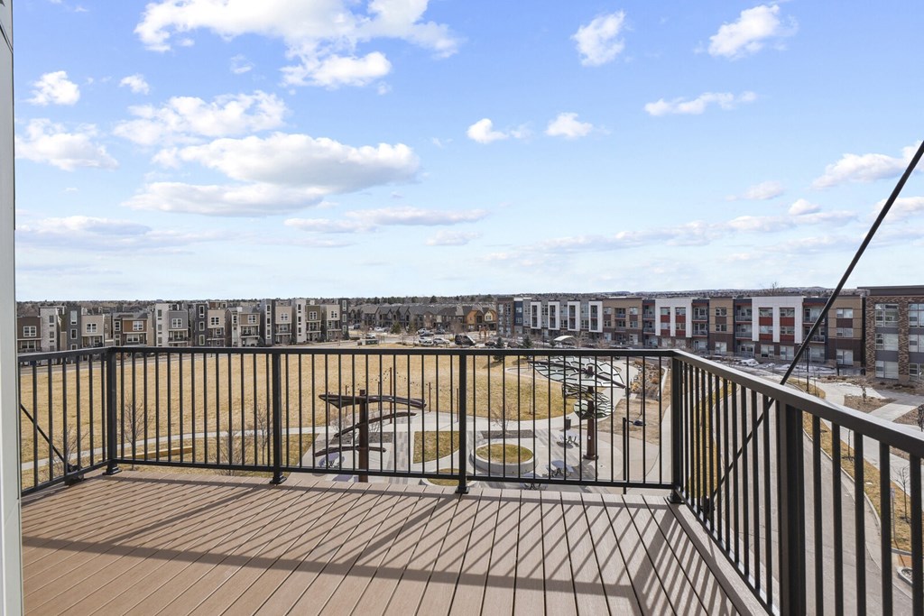 a balcony with a view of a playground and a city at Parkside at Littleton Village, Colorado