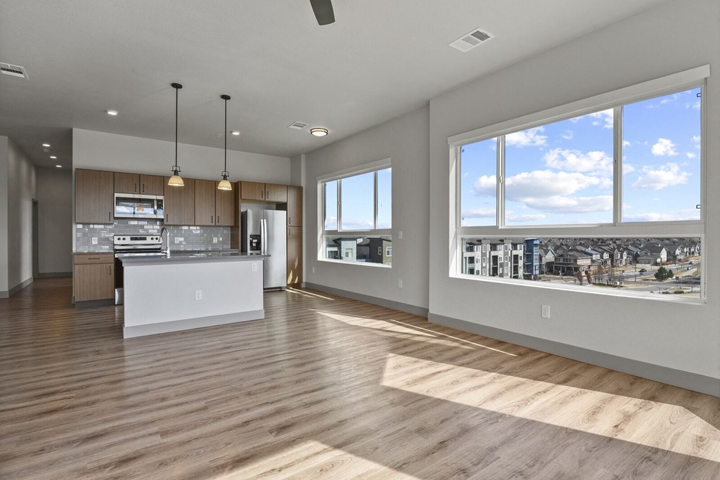 an open kitchen and living room with a view of the city at Parkside at Littleton Village, Colorado, 80122
