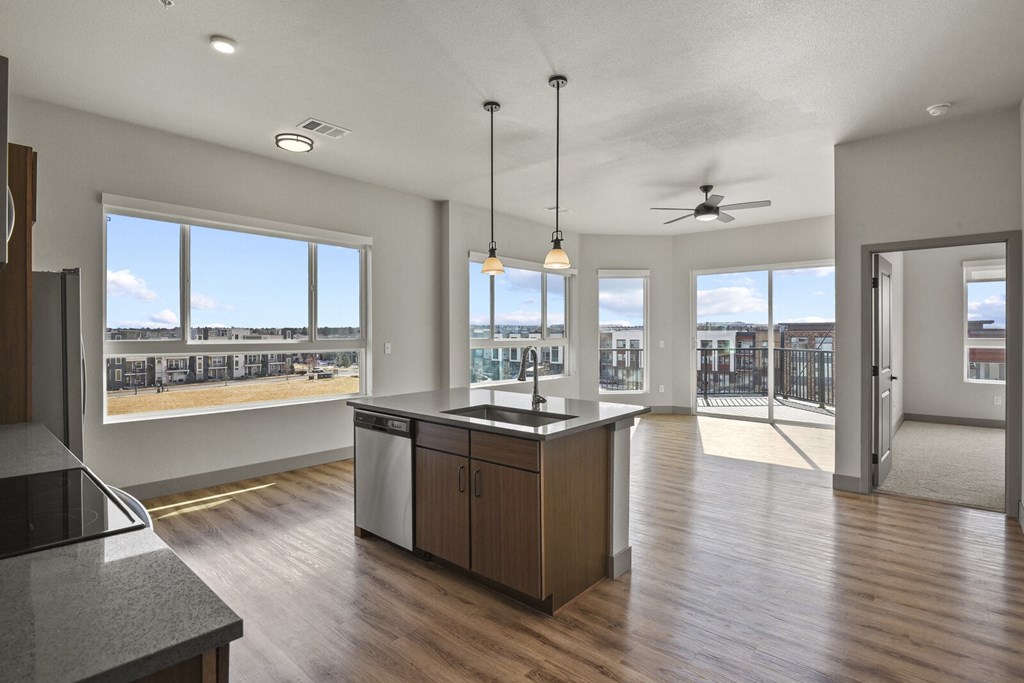 an open kitchen and living room with a view of the city at Parkside at Littleton Village, Colorado, 80122