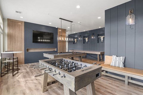 a game room with a foosball table and a tv at Parkside at Littleton Village, Littleton, Colorado