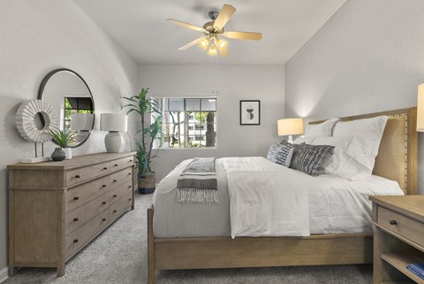 the master bedroom in a new home with a bed and dresser at Vaseo Apartments, Phoenix, AZ