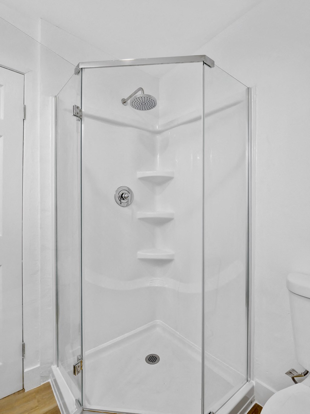 A white bathroom with a walk in shower at Verandas Apartments, West Covina, California