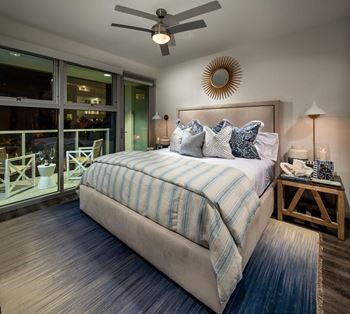 A bedroom with a large bed and a ceiling fan.at Chelsea Santa Monica, Santa Monica, CA  