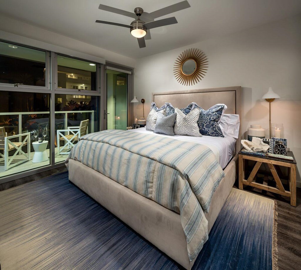A bedroom with a large bed and a ceiling fan.at Chelsea Santa Monica, California  