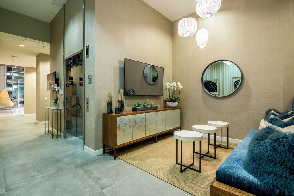 A modern bedroom with a large bed and a mirror on the wall.at Chelsea Santa Monica, Santa Monica, 90411  