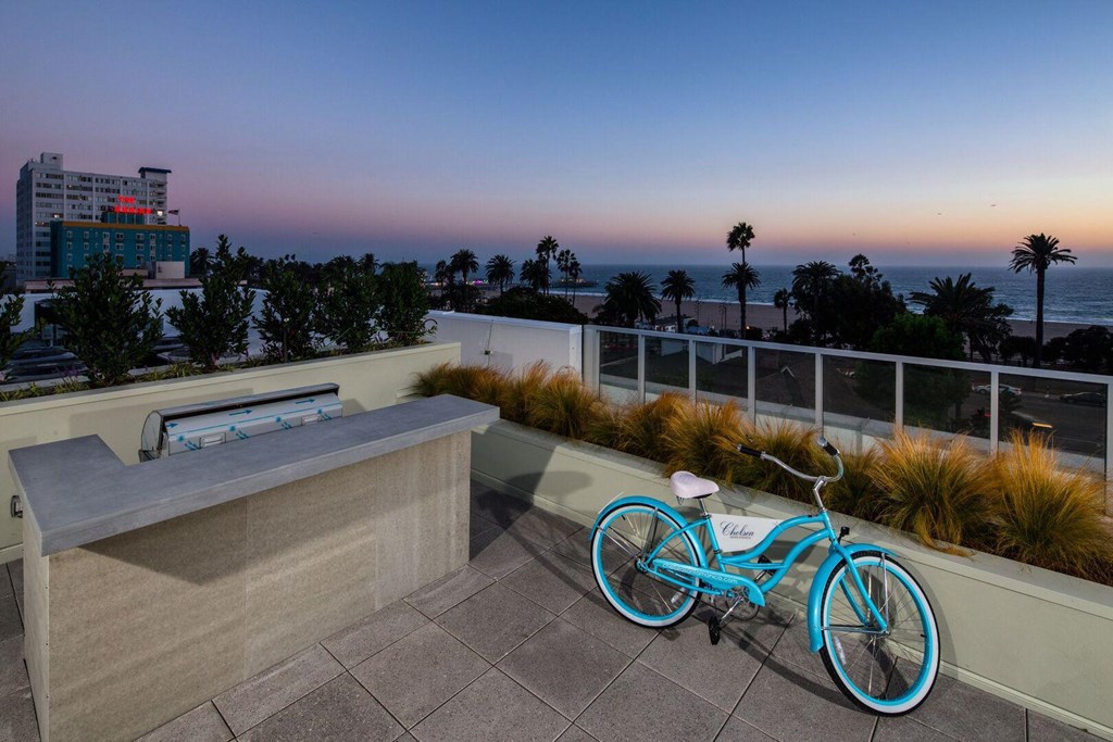 A blue bicycle is parked on a patio overlooking the ocean.at Chelsea Santa Monica, Santa Monica California  