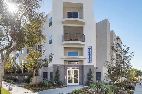 A modern building with a balcony on the second floor.at Grand View Towers, Los Angeles, CA  
