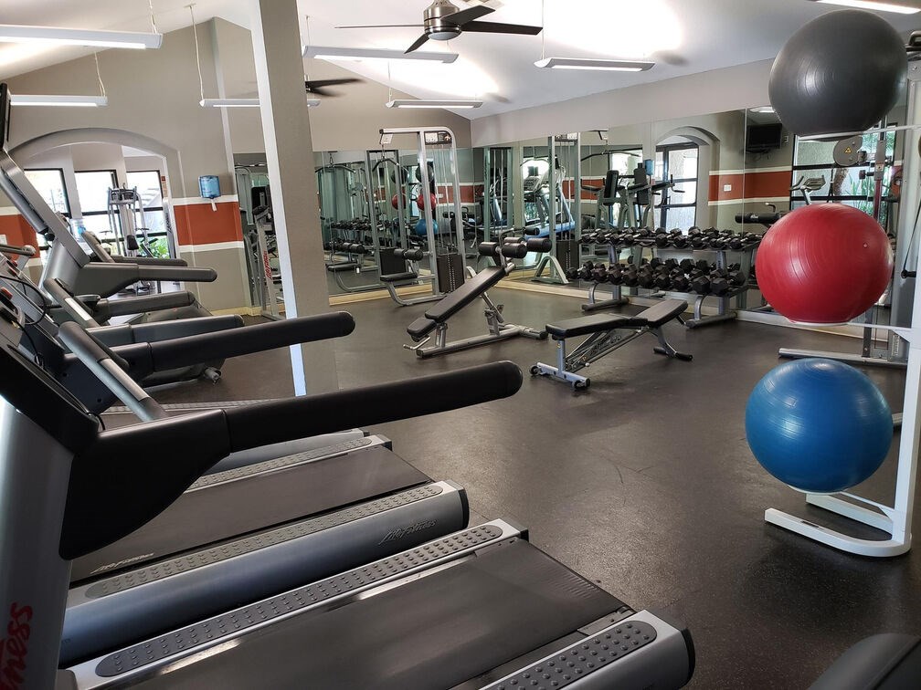 A gym with treadmills, dumbbells, and exercise balls. A gym with treadmills, dumbbells, and exercise balls.at Solterra At Civic Center, Norwalk, CA