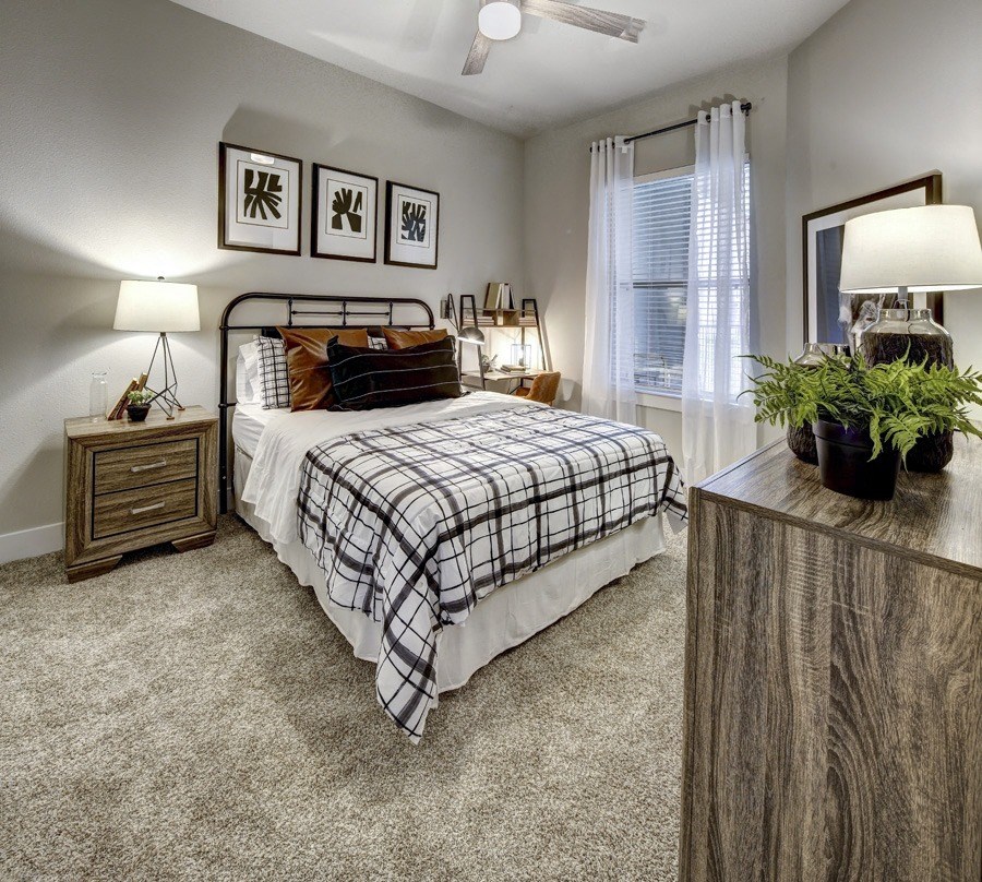 a bedroom with a bed and a table at Arise Riverside, Austin, TX 78741