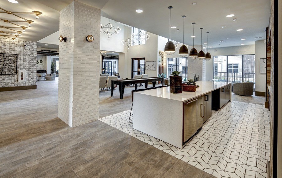 a large kitchen with a large island and a dining room at Arise Riverside, Austin, TX