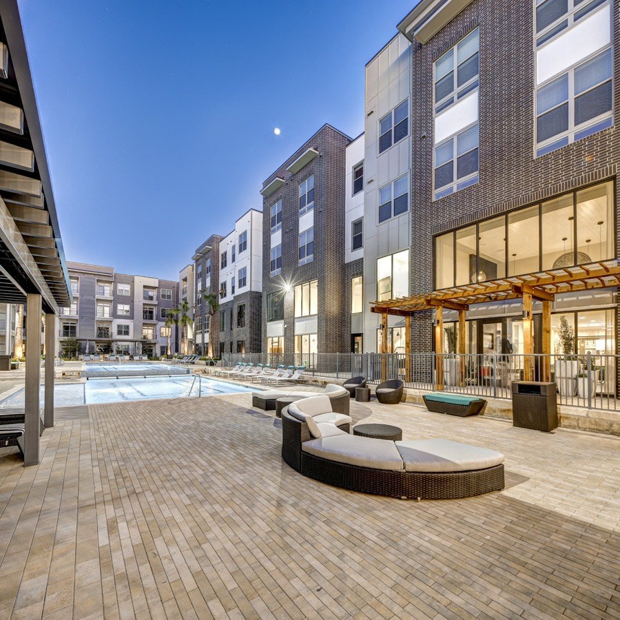 apartments with a swimming pool at dusk at Arise Riverside, Austin Texas