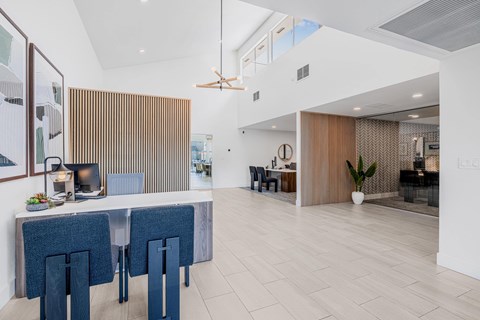 A modern dining area with a long table and chairs.