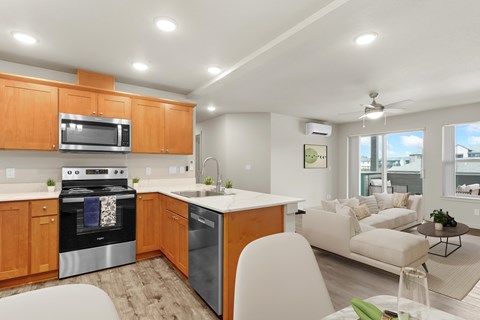 A modern kitchen with wooden cabinets and stainless steel appliances.