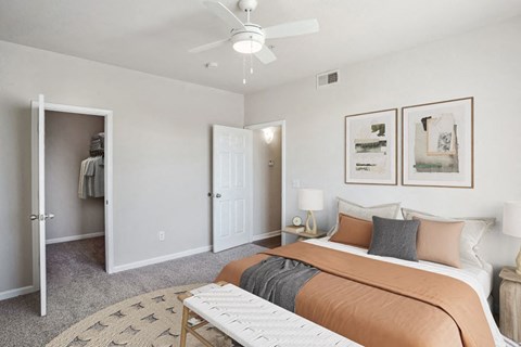 a bedroom with a bed and a ceiling fan