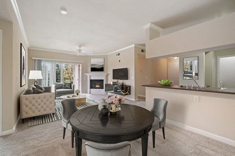 A modern dining room with a black table and chairs.